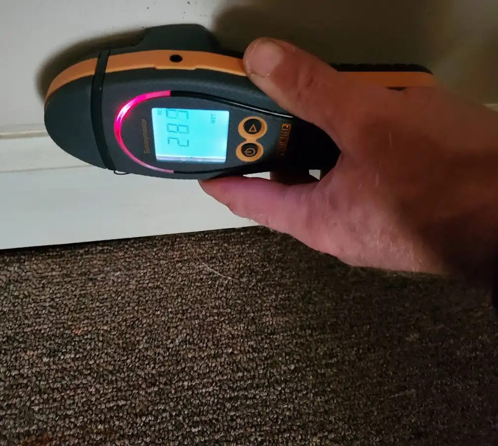 Moisture detection at baseboard during Storm Damage Restoration in New Kingman-Butler
